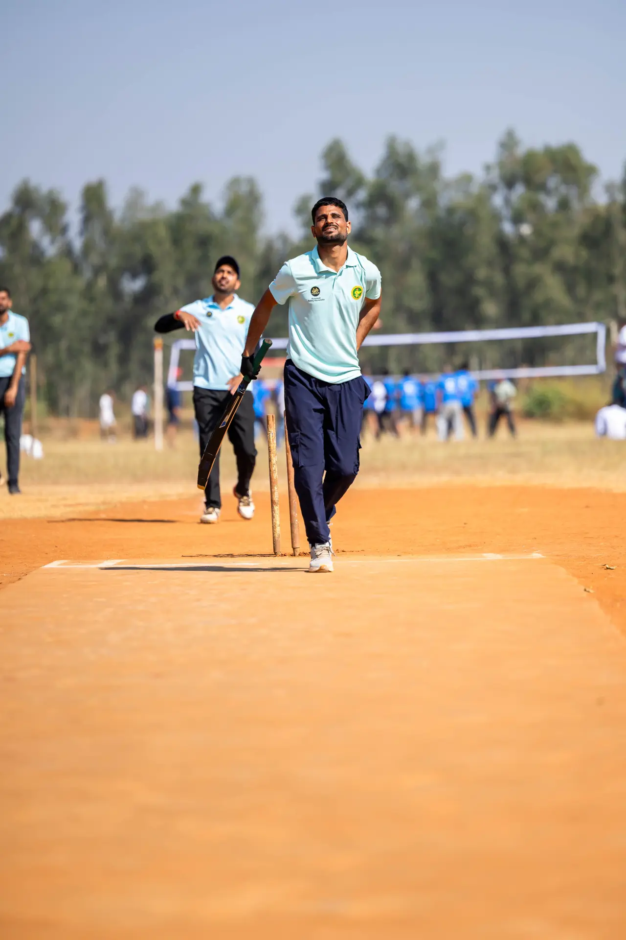 Cricketer bowling on an outdoor field